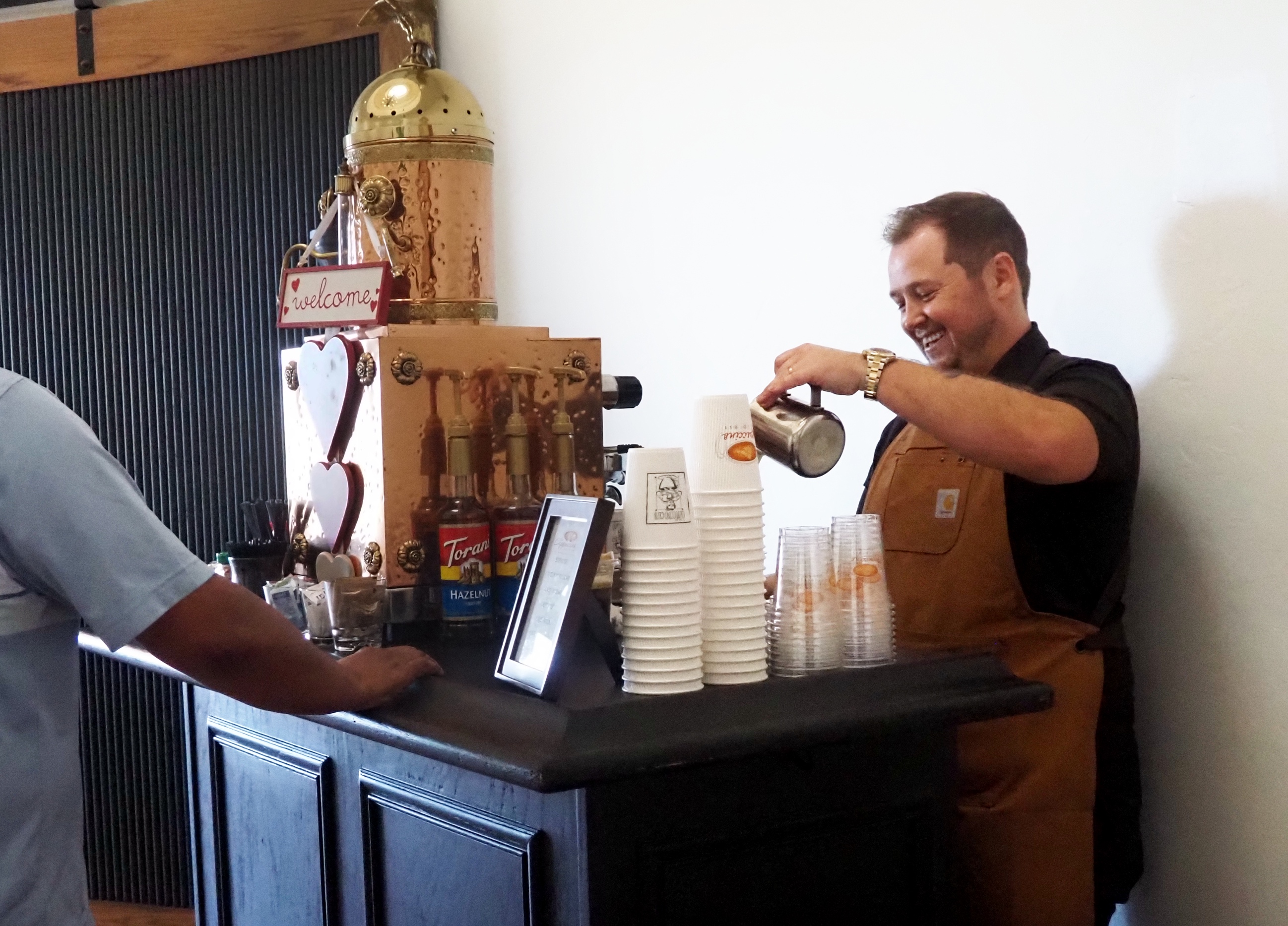 Tyler, founder of The Cappuccino Express, crafting drinks at an event